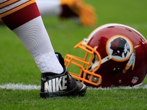 A Washington Redskins Nike cleat and helmet is seen on the field before the game against the Philadelphia Eagles at Lincoln Financial Field in Philadelphia on Sept. 21, 2014. (Rob Carr/Getty Images/AFP)
