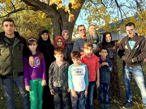 Photo courtesy of PEC Syria co-chairwoman Carlyn Moulton
Members of the the Al Jassam family: Abdel Malek and his wife Sawsen, his mother Hadji, and their children Slieman, Ramez, Khatim, Ahmed, Rahef, Siham, Walaa, Alaa, Mijed, Bachar, and the baby Fadl pose for a photo Tuesday, Nov. 3, 2015.