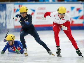 Jack Whelbourne of Britain (left) falls next to Park Se Yeong of South Korea (middle) and Patrick Duffy of Canada as they compete in the men’s 1000-metre quarterfinals at the World Short Track Speed Skating Championships in Moscow March 15, 2015. (REUTERS/Maxim Zmeyev)