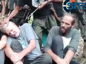 An image from video released by the Abu Sayyaf terrorist group of the reported hostages, including two Canadians, is pictured. (Handout/Postmedia Network)