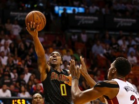 Nov 3, 2015; Miami, FL, USA; Atlanta Hawks guard Jeff Teague (0) drives to the basket as Miami Heat center Hassan Whiteside (21) looks on during the second half at American Airlines Arena. The Hawks won 98-92. Mandatory Credit: Steve Mitchell-USA TODAY Sports