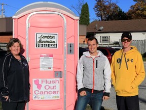 The Canadian Cancer Society's Paula McKinlay poses with Lambton Sanitation owners Clint, centre, and Josh Schenk by a pink porta-potty that toured business sites in Sarnia-Lambton last month to raise money in the fight against breast cancer. Organizers raised more than $7,000 and plan to host another Flush Out Cancer fundraiser next year. (Handout/Sarnia Observer/Postmedia Network)
