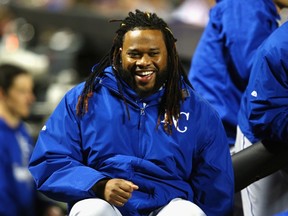 Johnny Cueto #47 of the Kansas City Royals laughs against the New York Mets during Game Three of the 2015 World Series at Citi Field on October 30, 2015 in New York City.   Mike Stobe/Getty Images/AFP