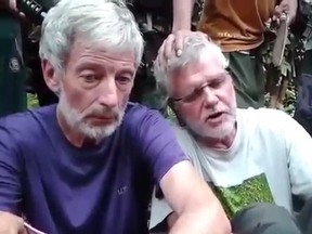 Robert Hall, left, and John Ridsdel are seen in this still image taken from a previous undated militant video. Canadians Hall and Ridsdel, a Norwegian man and a Filipina woman were taken hostage by gunmen from the Holiday Ocean View Samal Resort on Samal Island in the Philippines in September. (THE CANADIAN PRESS/HO via Youtube)