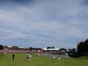 Bubba Watson and David Hearn of Canada walk up the 18th hole during the final round of the RBC Canadian Open at Glen Abbey Golf Club in Oakville on July 26, 2015. (Vaughn Ridley/Getty Images/AFP)