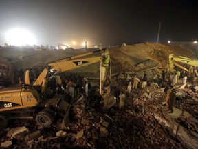 Rescue workers search for survivors after a factory collapsed near the eastern city of Lahore, Pakistan November 4, 2015. At least 18 people were killed and up to 150 trapped on Wednesday when a factory collapsed near the eastern Pakistani city of Lahore, officials said, adding to a number of industrial disasters to hit the South Asian nation.  REUTERS/Mohsin Raza