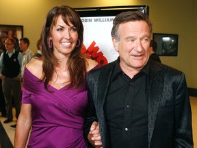 Actor Robin Williams, star of the film "World's Greatest Dad" escorts his wife Susan Schneider (L) at the film's premiere in Los Angeles, California in an August 13, 2009 file photo. REUTERS/Fred Prouse/files