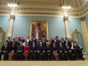 Prime Minister Justin Trudeau, fifth from left, and Governor General David Johnston, centre, pose for a group photo with the new Liberal cabinet at Rideau Hall in Ottawa on Wednesday, Nov. 4, 2015. Front row, left to right: Minister of Public Safety and Emergency Preparedness Ralph Goodale, Minister of Justice and Attorney General of Canada Jody Wilson-Raybould, Minister of Foreign Affairs Stephane Dion, Minister of International Trade Chrystia Freeland, Prime Minister Justin Trudeau, also minister of intergovernmental affairs and youth, Governor General David Johnston, Minister of Immigration, Refugees and Citizenship John McCallum, Minister of Public Services and Procurement Judy Foote, Minister of Agriculture and Agri-Food Lawrence MacAulay, Minister of Indigenous and Northern Affairs Carolyn Bennett and Minister of Veterans Affairs Kent Hehr, also associate minister of National Defence. Second row, left to right: President of the Treasury Board Scott Brison, Minister of International Development and La Francophonie Marie-Claude Bibeau, Minister of Innovation, Science and Economic Development Navdeep Singh Bains, Minister of National Revenue Diane Lebouthillier, Minister of Families, Children and Social Development Jean-Yves Duclos, Minister of Employment, Workforce Development and Labour MaryAnn Mihychuk, Minister of Transport Marc Garneau, Minister of Environment and Climate Change Catherine McKenna, Minister of Finance William Morneau, Minister of Canadian Heritage Melanie Joly, Leader of the Government in the House of Commons Dominic LeBlanc and Minister of Health Jane Philpott. Third row, left to right: Minister of Sport and Persons with Disabilities Carla Qualtrough, Minister of Natural Resources James Carr, Minister of Science Kirsty Duncan, Minister of Infrastructure and Communities Amarjeet Sohi, Minister of Small Business and Tourism Bardish Chagger, Minister of Fisheries, Oceans and the Canadian Coast Guard Hunter Tootoo, Minister of Status of Women Patricia A. Hajdu, Minister of National Defence Harjit Singh Sajjan and Minister of Democratic Institutions Maryam Monsef. THE CANADIAN PRESS/Adrian Wyld