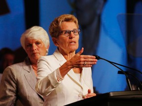 Ontario Premier Kathleen Wynne speaks to the Elementary Teachers Federation of Ontarioin August 2014 as Education Minister Liz Sandals listens.  (Stan Behal/Toronto Sun)