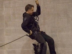 Facebook is loving a photo of a terrified-looking police dog named Niko rappelling with his handler in a training exercise.  (Facebook/Postmedia Network )