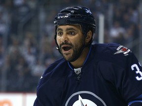 Winnipeg Jets defenceman Dustin Byfuglien calls out to his defence partner during NHL action against the Calgary Flames at MTS Centre in Winnipeg on Oct. 16, 2015. (Kevin King/Winnipeg Sun/Postmedia Network)