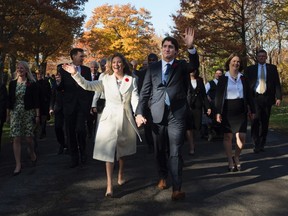 Prime minister-designate Justin Trudeau walks with his wife Sophie Gregoire-Trudeau as he arrives to Rideau Hall with his future cabinet to take part in a swearing-in ceremony in Ottawa on Wednesday, November 4, 2015. THE CANADIAN PRESS/Sean Kilpatrick