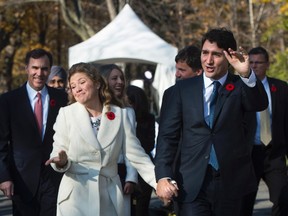 Prime minister-designate Justin Trudeau walks with his wife Sophie Gregoire-Trudeau as he arrives to Rideau Hall with his future cabinet to take part in a swearing-in ceremony in Ottawa on Wednesday, November 4, 2015. THE CANADIAN PRESS/Sean Kilpatrick