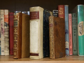 Three rare books on the shelf at Rockcliffe Park Public School in Ottawa Wednesday, Nov. 4, 2015. John Milton's Paradise Lost,  Persian Poetry and French Treatise on Tulips will be part of the upcoming sale. Tony Caldwell/Ottawa Sun/Postmedia Network