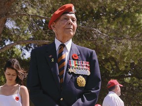 Late Belleville veteran Bob Wigmore stands by the grave of fellow Hastings and Prince Edward Regiment soldier C.E. McCormick at the Canadian war cemetery in Agira, Sicily in July 2013. This photo appears on the back cover of Mark Zuehlke's new book about the trip, Through Blood and Sweat. Wigmore is also in Max Fraser's film, Bond of Strangers, about the same trip. Louis-Philippe Dube photo/Courtesy of Douglas & McIntyre