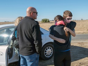 University of California, Merced student Justin Dick, right, hugs his sister Kristen as his parents Beth and Keith look on following a stabbing in Merced, Calif., Wednesday, Nov. 4, 2015. An assailant stabbed five people at the rural university campus in central California before police shot and killed him, authorities said Wednesday. Justin was one of 15 students in the core class where the incident took place Wednesday morning. (Paul Kitagaki Jr.(Paul Kitagaki Jr./The Sacramento Bee via AP)