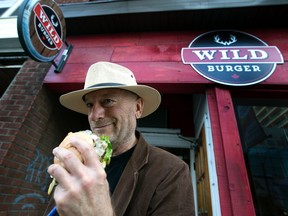 Toronto Sun Columnist Mike Strobel tries a Kangaroo Burger at Wild Burger on Wednesday November 4, 2015. Dave Abel/Toronto Sun