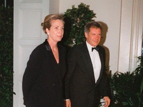 In this Feb. 5, 1998 file photo, Harrison Ford and his wife Melissa Mathison arrive at the White House for an official dinner for the British Prime Minister hosted by President Clinton in Washington. Mathison, the screenwriter who crafted the enchanting worlds of iconic family films including "E.T. the Extra Terrestrial," has died. She passed away Wednesday, Nov. 4, 2015, at age 65 after a bout with neuroendocrine cancer, her sister, Melinda Mathison Johnson, confirmed.  Mathison was married to Harrison Ford for 21 years and divorced in 2004. (AP Photo/Neshan H. Naltchayan, File)