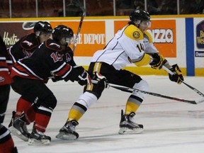 Sarnia Sting forward Pavel Zacha reaches to keep the puck away from pursuing Owen Sound Attack defenders, from left, Liam Dunda and Bryson Cianfrone during the Ontario Hockey League game at the Harry Lumley Bayshore Community Centre in Owen Sound Wednesday night. Zacha scored a power-play goal in a 4-3 overtime victory. (Terry Bridge, Sarnia Observer)
