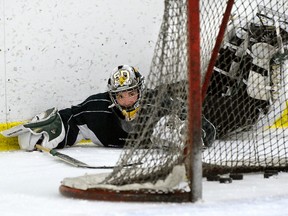 London Knights goalie Tyler Parsons dives for a loose puck behind his net during practice at the Western Fair Sports Centre on Wednesday. (MORRIS LAMONT, The London Free Press)