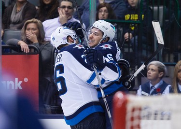 Winnipeg Jets' Alexander Burmistrov, right, celebrates his game-winning goal with teammate Blake Wheeler during third period NHL hockey action against the Toronto Maple Leafs, in Toronto, on Wednesday, Nov. 4, 2015. THE CANADIAN PRESS/Darren Calabrese