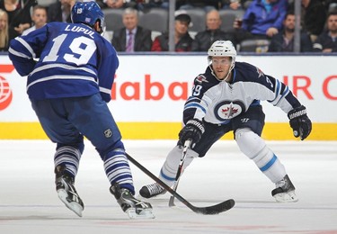 TORONTO, ON - NOVEMBER 4: Toby Enstrom #39 of the Winnipeg Jets defends against Joffrey Lupul #19 of the Toronto Maple Leafs during an NHL game at the Air Canada Centre on November 4, 2015 in Toronto, Ontario, Canada.   Claus Andersen/Getty Images/AFP
== FOR NEWSPAPERS, INTERNET, TELCOS & TELEVISION USE ONLY ==