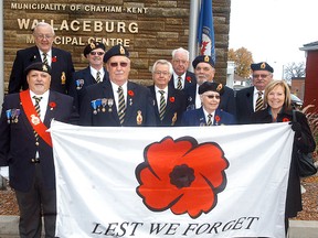 Members of the Wallaceburg Legion, along with Ward 5 (Wallaceburg) councillor Carmen McGregor, far right, raise the Legion poppy flag at the Wallaceburg municipal service centre on Oct. 30.