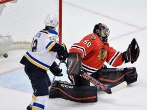 Chicago Blackhawks goalie Corey Crawford (50), misses the winning goal by St. Louis Blues' Vladimir Tarasenko (91), of Russia, while St. Louis Blues' Jori Lehtera (12), of Finland, looks on during overtime of a hockey game Wednesday, Nov. 4, 2015, in Chicago.  St. Louis won 6-5 in overtime. (AP Photo/Paul Beaty)