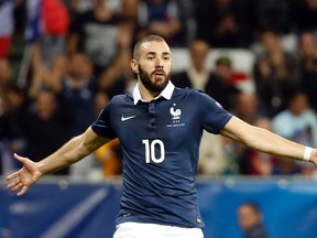France's Karim Benzema celebrates after scoring during their friendly soccer match against Armenia at Allianz Riviera stadium in Nice, France. in this October 8, 2015 photo. France soccer International and Real Madrid striker Karim Benzema was placed under formal judicial investigation on Thursday in connection with an alleged attempt to blackmail fellow-France soccer international Mathieu Valbuena with the use of a sex video.   Picture taken October 8, 2015.   REUTERS/Eric Gaillard