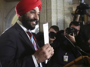 Canada's Innovation, Science and Economic Development Minister Navdeep Bains holds up a copy of a long-form census during a news conference on Parliament Hill in Ottawa, on Nov. 5, 2015. (REUTERS/Chris Wattie)