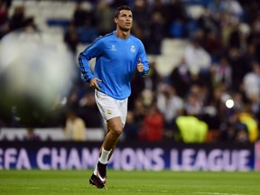 Real Madrid's Portuguese forward Cristiano Ronaldo warms up before the UEFA Champions League football match against Paris Saint-Germain (PSG) at the Santiago Bernabeu stadium in Madrid on Nov. 3, 2015. (AFP PHOTO/JAVIER SORIANO)