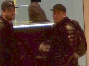 Investigators need help identifying these two men who are suspected of stealing a watch worth nearly $15,000 from a downtown store. (Toronto Police handout)