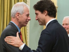 Newly sworn in Minister of Foreign Affairs Stephane Dion is congratulated by Prime Minister Justin Trudeau during a ceremony at Rideau Hall, in Ottawa, on Wednesday, Nov. 4, 2015. Dion says the new Liberal government backs TransCanada Corp's Keystone XL pipeline. THE CANADIAN PRESS/Sean Kilpatrick