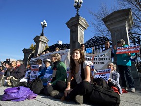 Environmental activists, including Lucy Lambert (front right) sit outside the main entrance to the grounds of Rideau Hall, where Prime Minister Justin Trudeau resides.  Thursday November 5, 2015. Errol McGihon/Ottawa Sun/Postmedia Network