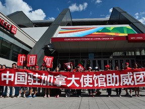 Fans of China pose before a 2015 FIFA Women's World Cup quarterfinal match against the USA at Lansdowne Stadium in Ottawa on June 26, 2015.    AFP PHOTO/NICHOLAS KAMM