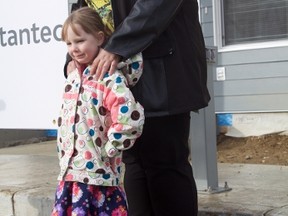 Carrie Levins and daughter Amie about to receive the keys to their new home in Neufeld Landing on October 29.