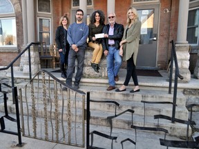 Silvia Langer, development director, Unity Project for Relief of Homelessness (centre), receives a $4,215 donation from the London Home Builders’ Association on the front steps of the Unity Project’s Dundas Street location in London Ont. November 3, 2015. Also pictured, from left to right: Stefanie Coleman-Dias, owner, Coleman-Dias Construction, Peder Madsen, co-owner, CCR Building & Remodeling Inc., Patrick Malloy, owner, Duo Building Ltd., and Anita Schipper, communications officer, Unity Project. CHRIS MONTANINI\LONDONER\POSTMEDIA NETWORK