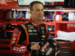 Kevin Harvick stands in the garage area during practice for the NASCAR Sprint Cup Series Goody's Headache Relief Shot 500 at Martinsville Speedway in Martinsville, Va., on Oct. 31, 2015. (Rainier Ehrhardt/Getty Images/AFP)