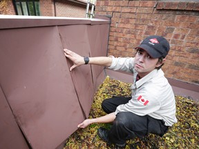 Mike Pollard, a bird and wildlife service technician for Orkin, investigates loose siding where the home owner was worried raccoons were trying to gain entry Thursday November 5, 2015. (Craig Robertson/Toronto Sun)