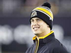 Injured Tiger-Cats quarterback Zach Collaros looks from the sidelines as his team plays the Stampeders during first half CFL action in Hamilton on Oct. 2, 2015. (Mark Blinch/Reuters)