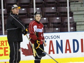 Sarnia Sting head coach Derian Hatcher explains a drill to his players while using centre Troy Lajeunesse as an example during Thursday's practice at the Sarnia Sports and Entertainment Centre. The Sting are home to the Flint Firebirds for the first time in Ontario Hockey League franchise history Friday night. (Terry Bridge, Sarnia Observer)