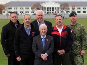 Jason Derbyshire, from left, associate dealer of Canadian Tire Cataraqui; Dan Gostlin, associate dealer of Canadian Tire on Division Street; Elwin Derbyshire associate dealer of Canadian Tire Cataraqui; Allan Jones, chairman of the Wall of Remembrance; Rick Smith associate dealer of Canadian Tire in the Kingston Centre, and Col. Stephen Kelsey, CFB Kingston base commander, at CFB Kingston on Thursday. Steph Crosier/The Whig-Standard)