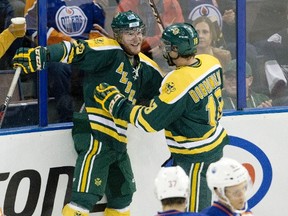 University of Alberta Golden Bears' Rhett Rachinski (20) and James Dobrowolski (18) celebrate a goal on the Edmonton Oilers during first period exhibition hockey action in September. The Bears host the Manitoba Bisons Friday and Saturday. (The Canadian Press)