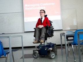 Fanshawe College business school instructor Jeff Preston sits in his elevated chair in a classroom at the college in London, Ont. on Friday October 30, 2015. Preston's chair allows him to elevate the seat, allowing him to work from behind the instructor's podium where he can utilize the audio-visual equipment. (CRAIG GLOVER, The London Free Press)