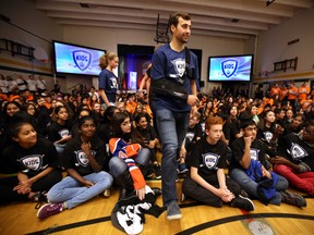 Jordan Eberle walks through a gym full of kids as Harrison and Chloe Katz launch their Hockey Helps Kids Foundation at Riverbend School on October 6, 2015 in Edmonton, Alta. Perry Mah/Edmonton Sun/Postmedia