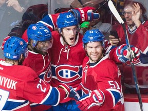 Canadiens' Dale Weise (22) celebrates with teammates Alex Galchenyuk (27), P.K. Subban (76) and David Desharnais (51) after scoring against the Islanders during first period NHL action in Montreal on Thursday, Nov. 5, 2015. (Graham Hughes/THE CANADIAN PRESS)