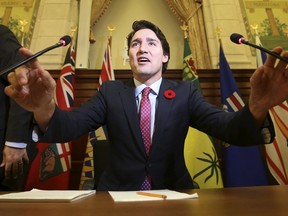 Canada's Prime Minister Justin Trudeau adjusts his microphones before speaking during a Liberal caucus meeting on Parliament Hill in Ottawa, Canada November 5, 2015. REUTERS/Chris Wattie      TPX IMAGES OF THE DAY