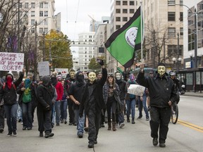 Anonymous activists wearing Guy Fawkes masks participate in the "Million Mask March" in Seattle, Washington November 5, 2015. Protesters blocked traffic as they marched to the Federal Courthouse and Amazon's campus in the South Lake Union neighborhood.  REUTERS/Jason Redmond