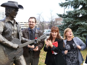 Greater Sudbury-based sculptor Tyler Fauvelle and Stompin' Tom Connors Commemorative Committee members Tannys Laughren, middle, and Honey Johnston were on hand to unveil a Stompin' Tom sculpture in front of the Sudbury Community Arena in Sudbury, Ont. on Thursday November 5, 2015. Fauvelle was commissioned by the committee to create the life-sized monument to honour Connors, who died on March 6, 2013. John Lappa/Sudbury Star/Postmedia Network