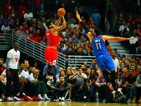 Chicago Bulls guard Derrick Rose (1) shoots over Oklahoma City Thunder center Enes Kanter (11) during the second half of an NBA basketball game in Chicago, on Thursday, Nov. 5, 2015. The Bulls won the game 104-98. (AP Photo/Jeff Haynes)